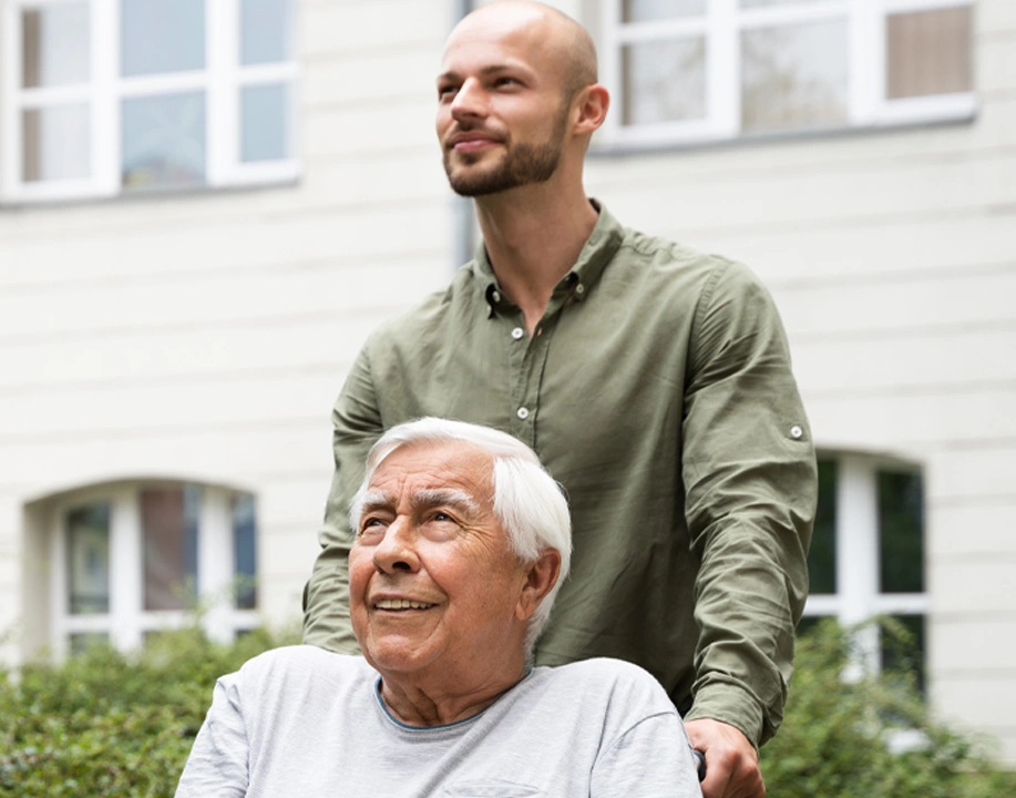 Elderly senior man in wheelchair with transport nurse