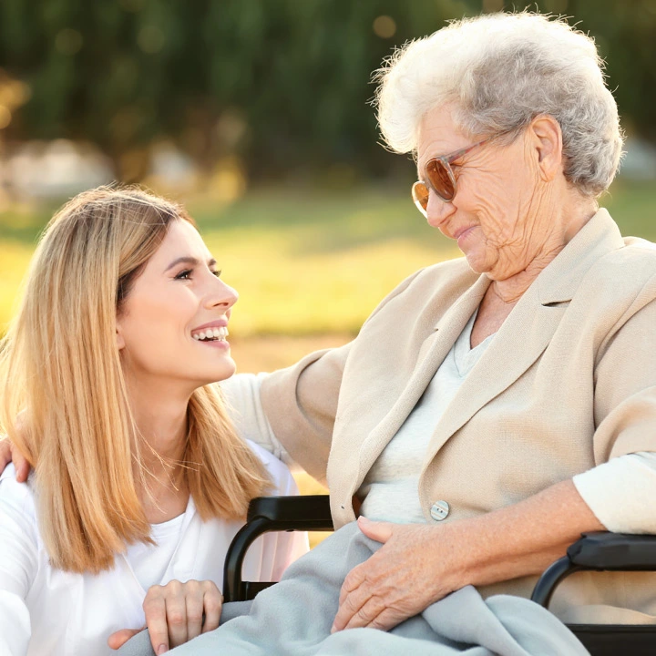 Elderly women in wheelchair with nurse